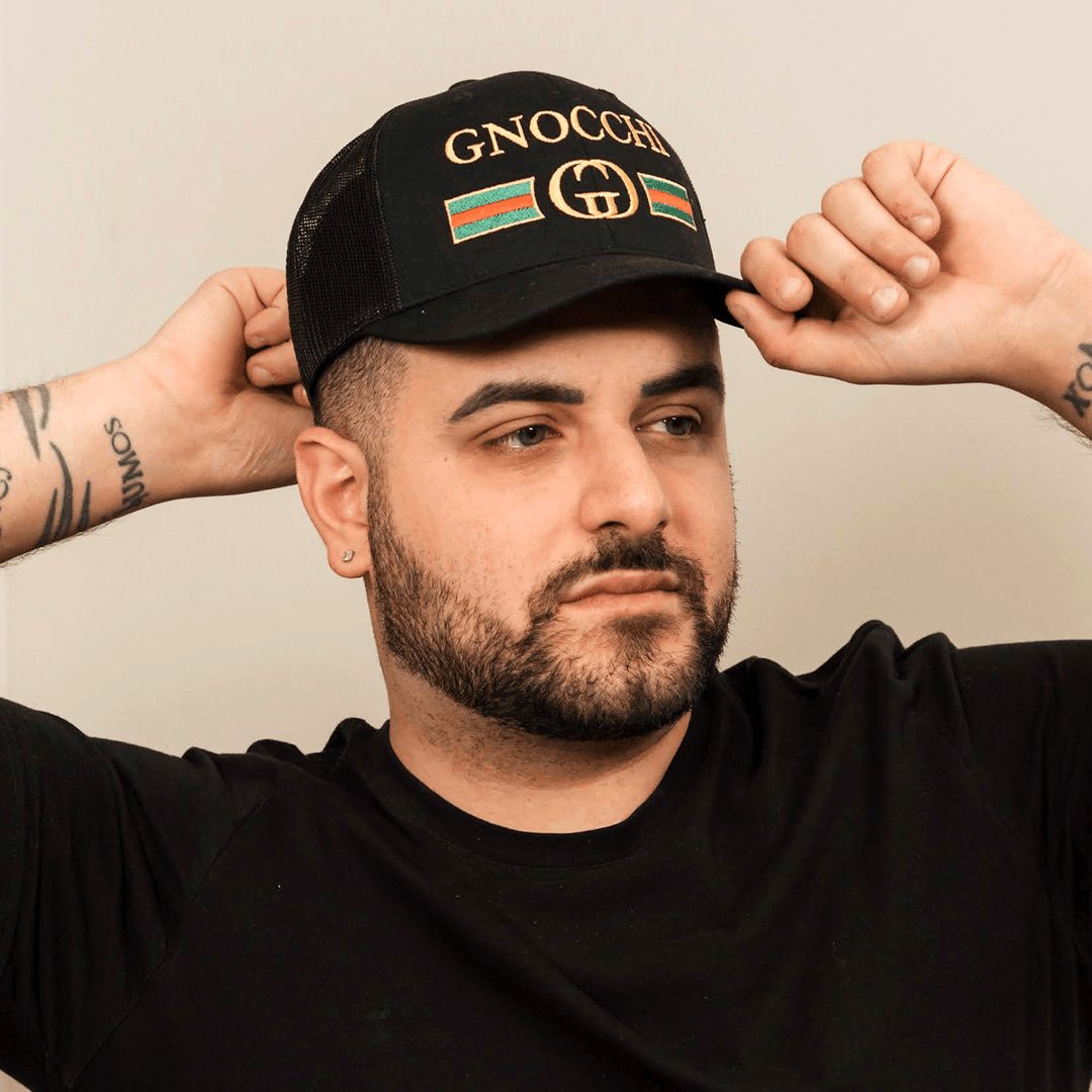 Man wearing black Gnocchi baseball cap